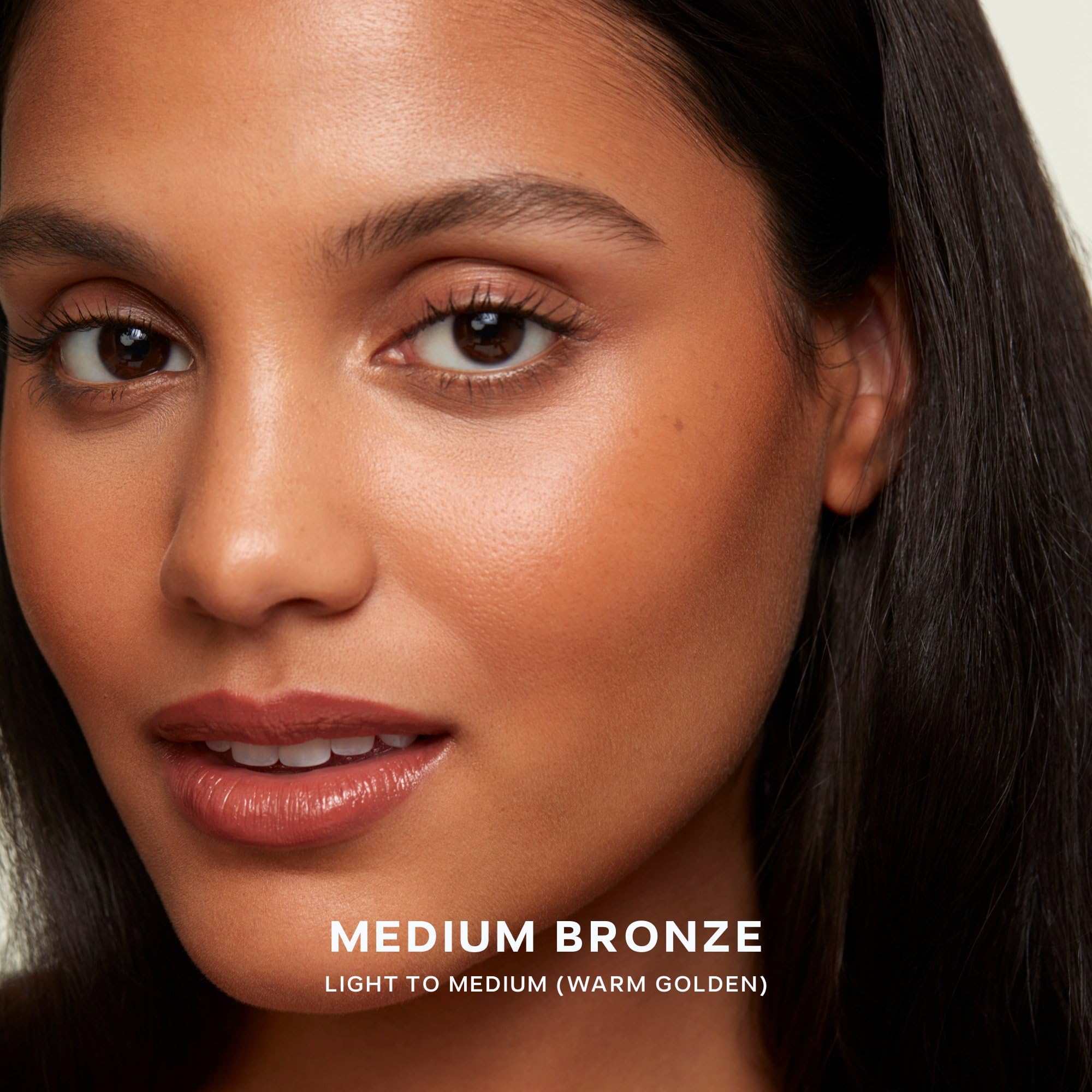 Saie buffing brush dipped into Sun Melt demonstrating effortless application benefit