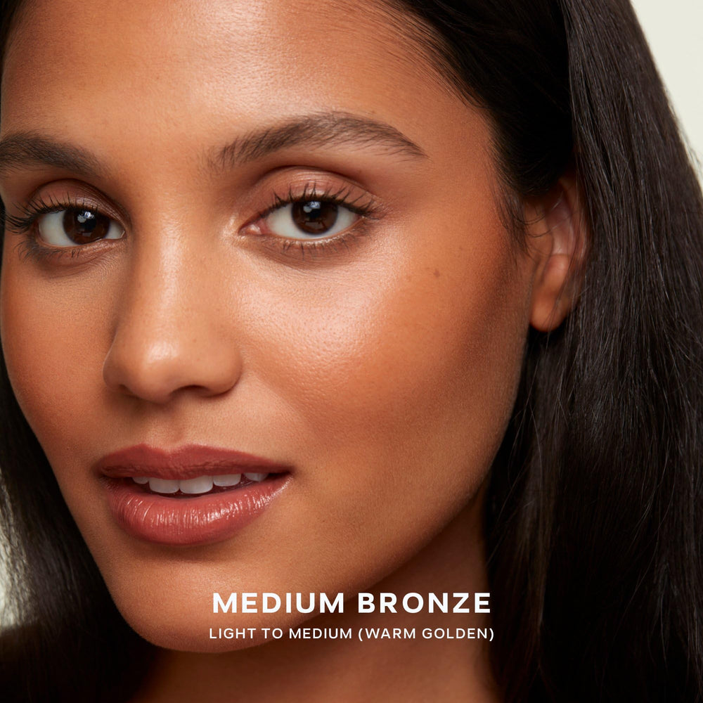 Saie buffing brush dipped into Sun Melt demonstrating effortless application benefit