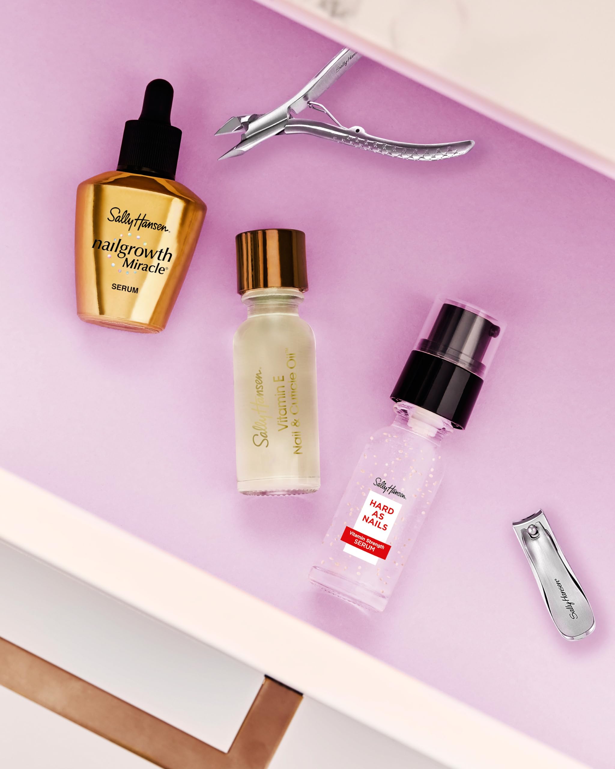 Sally Hansen bottle beside apricot kernel highlighting natural oils