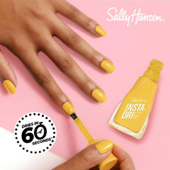 Sally Hansen nails painted 770 Hella Yella in lifestyle scene showing quick-dry glossy manicure benefit