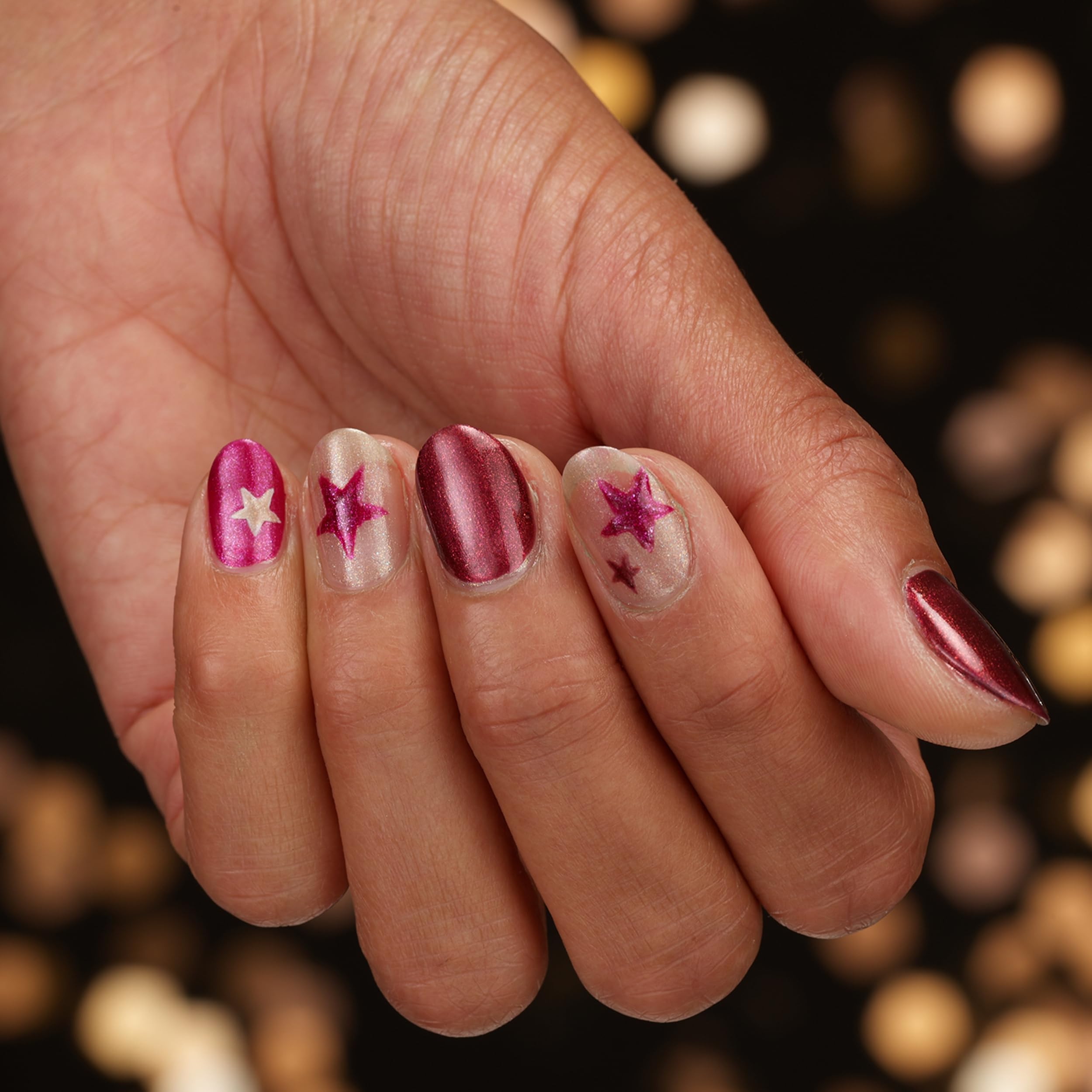 Sally Hansen Holiday Romance bottle next to coin for scale and travel-friendly size