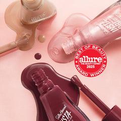 Sally Hansen bottle held against hand for scale showing compact size and portability benefit