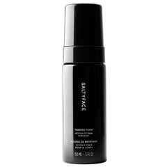 SALTYFACE compact pump bottle front showing clear foam and volume control benefit