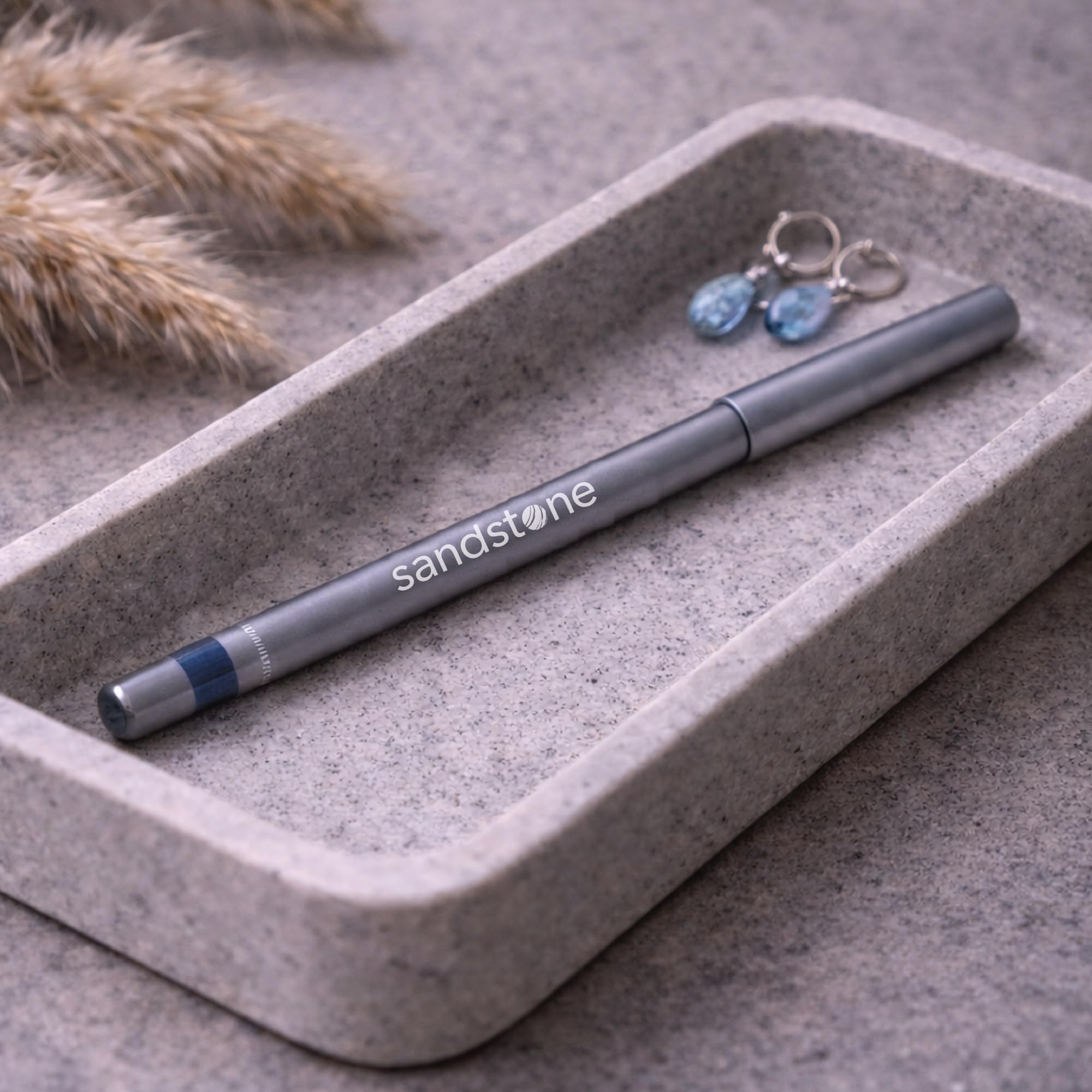 Sandstone Scandinavia pencil held next to hand showing true size and control