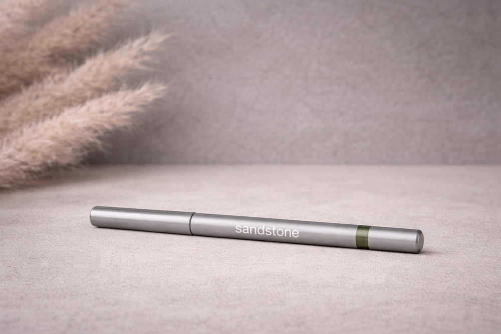 Sandstone Scandinavia pencil next to coin showing compact travel-friendly size benefit
