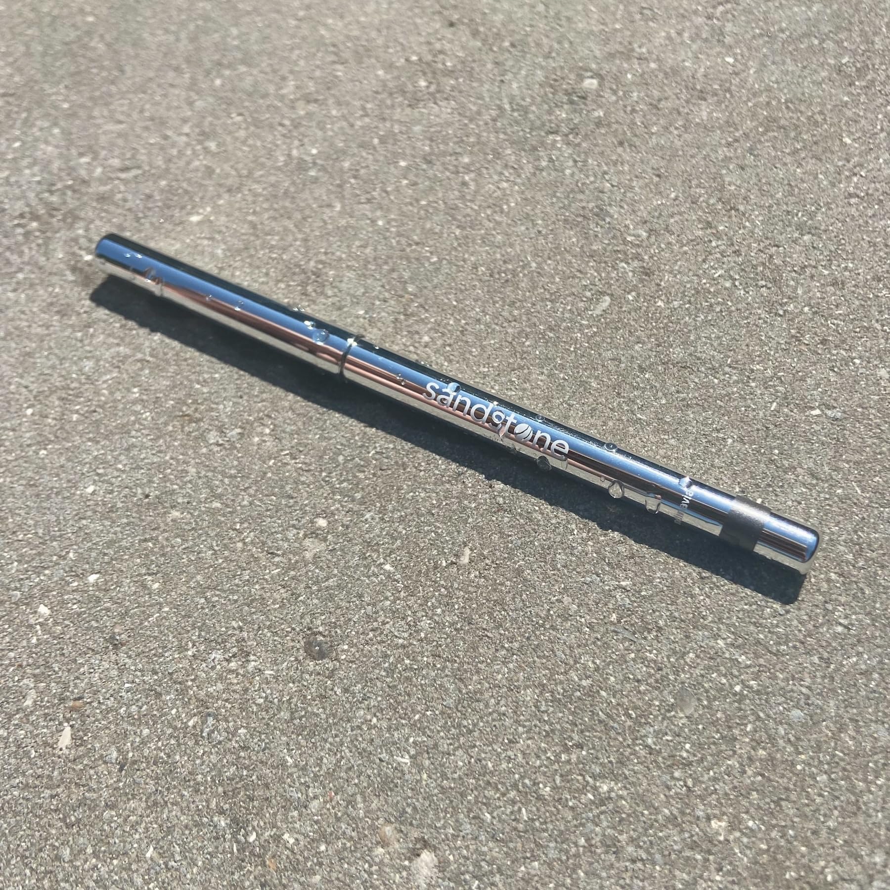 Sandstone Scandinavia pencil held in hand to show size and travel-friendly scale