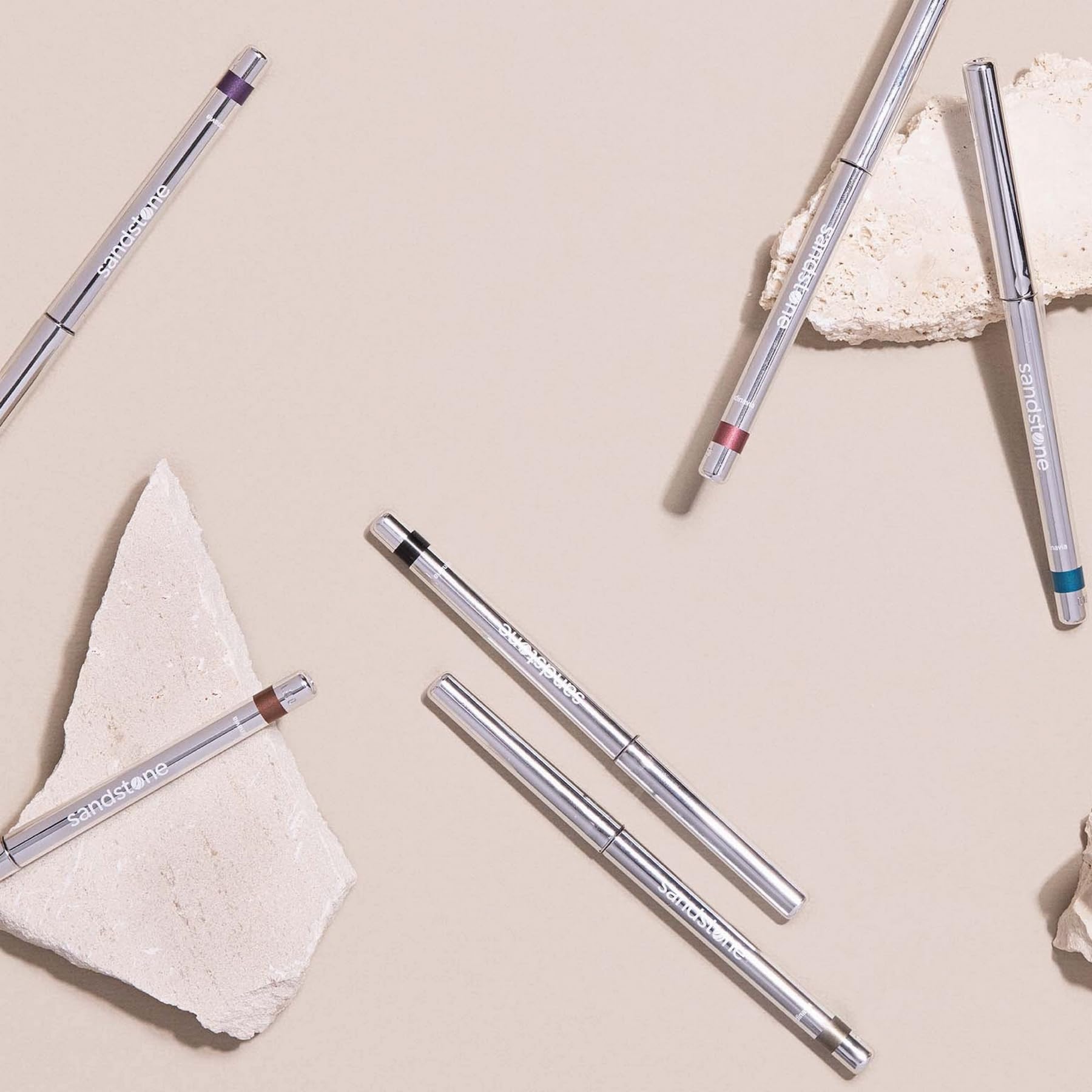 Sandstone Scandinavia eyeliner on vanity with brushes showing lifestyle-ready cosmetic appeal