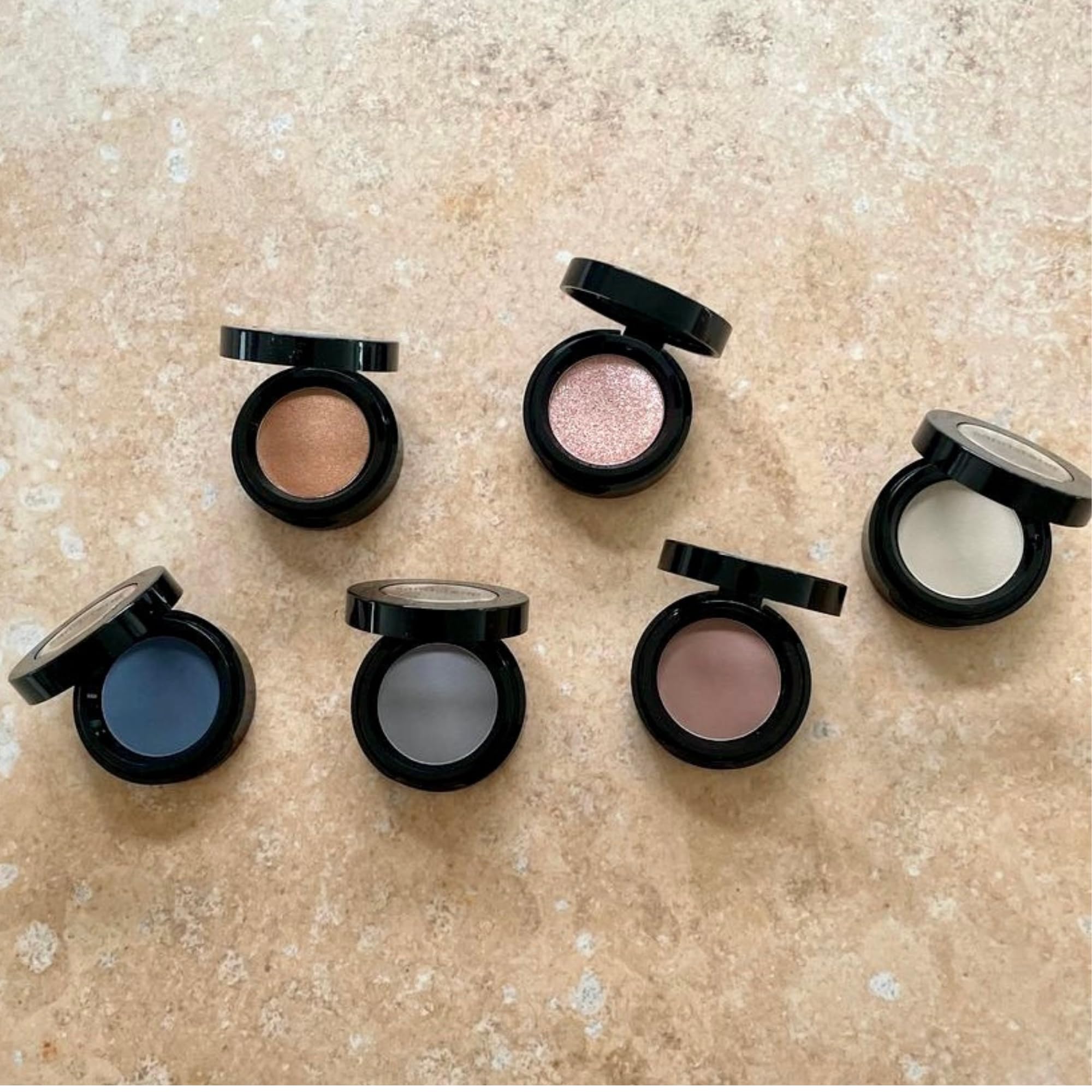 Sandstone Scandinavia eyeshadow 262 held in hand for scale showing compact size benefit: travel friendly