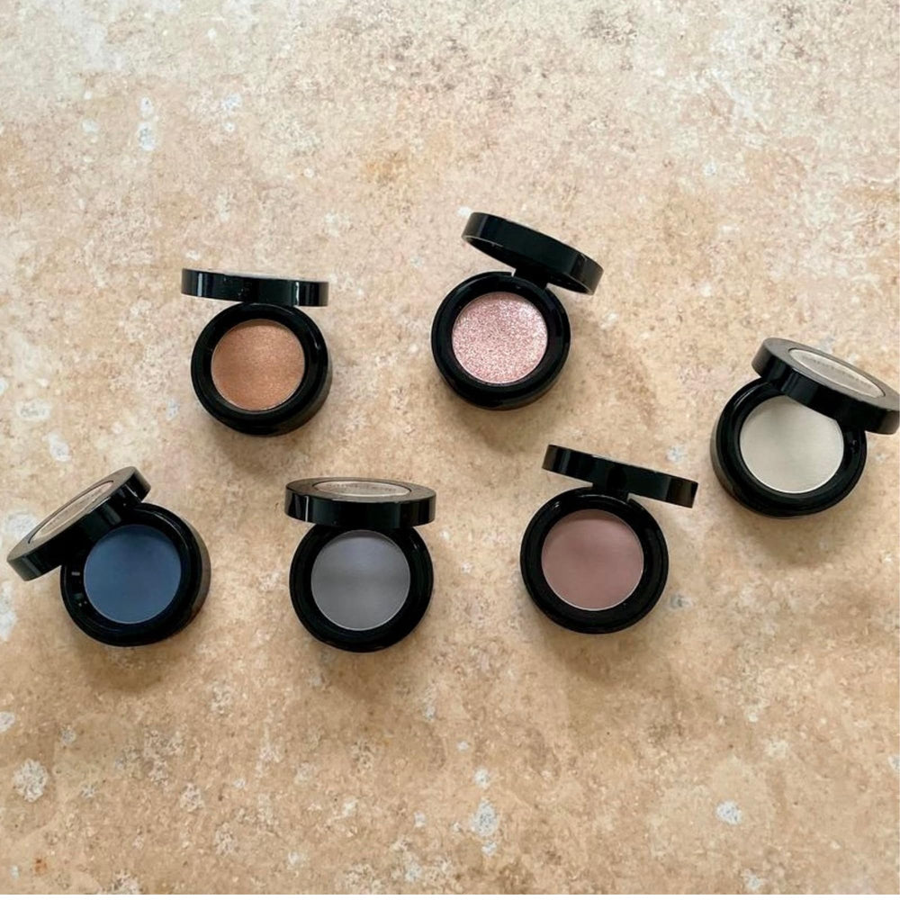 Sandstone Scandinavia eyeshadow 262 held in hand for scale showing compact size benefit: travel friendly