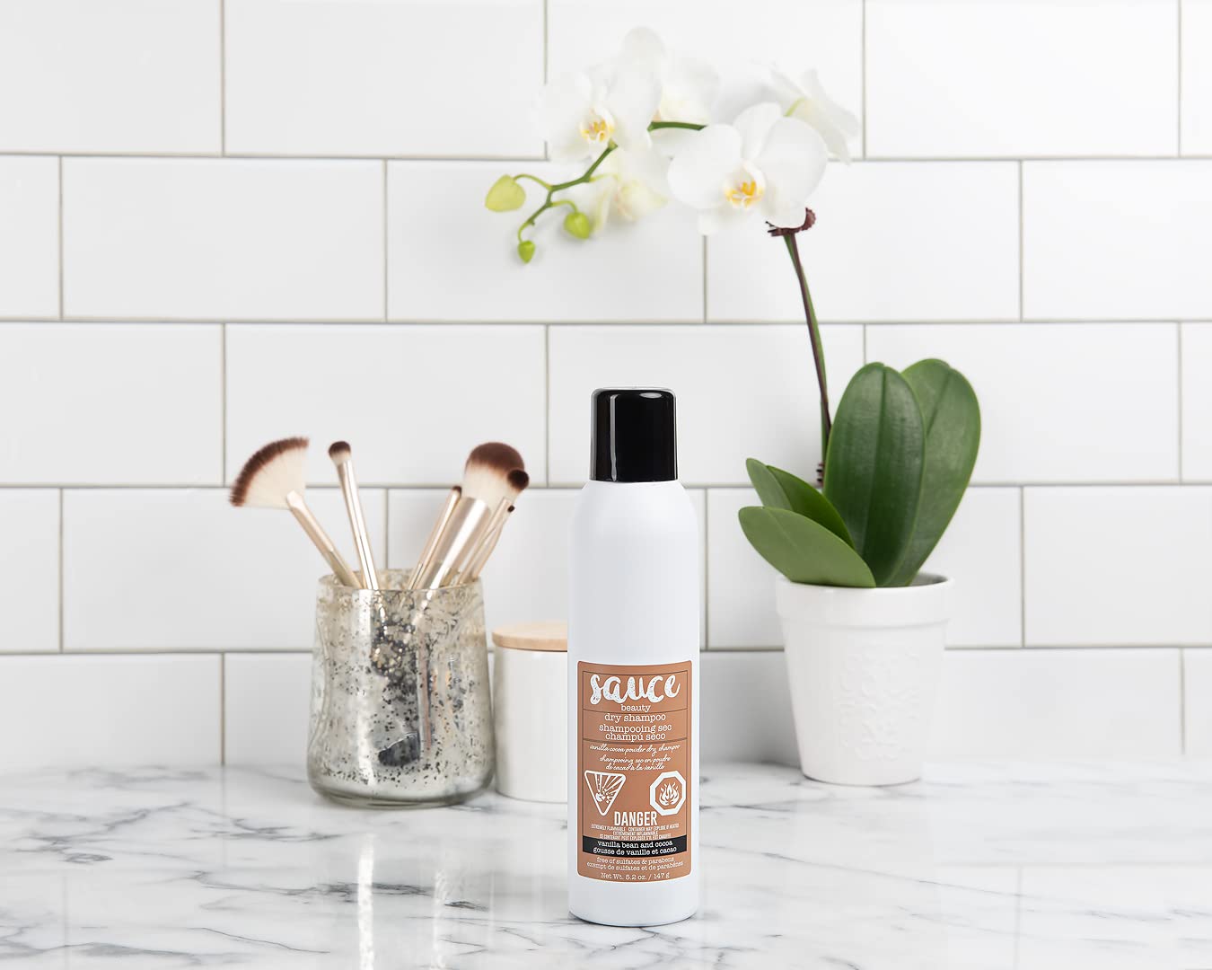 SAUCE BEAUTY powder spray mid-air showing lightweight absorbent texture