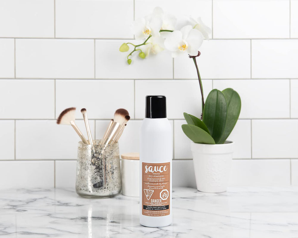 SAUCE BEAUTY powder spray mid-air showing lightweight absorbent texture
