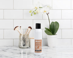 SAUCE BEAUTY powder spray mid-air showing lightweight absorbent texture