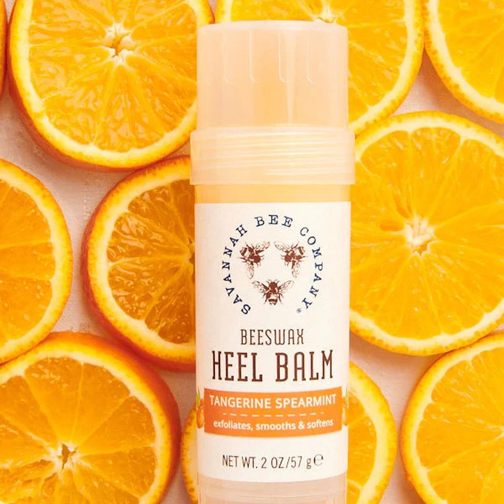 Applying Savannah Bee Company balm to a cracked heel to soothe and soften