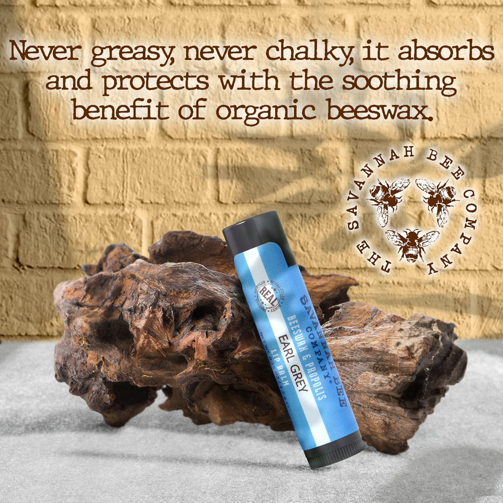 Hand applying Savannah Bee Company lip balm for instant hydration benefit