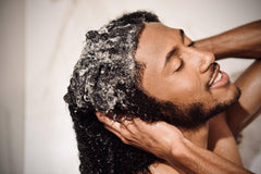 Man using Scotch Porter in shower showing real-world use for wavy and curly hair care