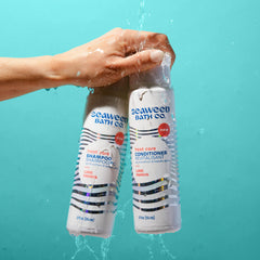 The Seaweed Bath Co. bottle held in hand showing 12 ounce size