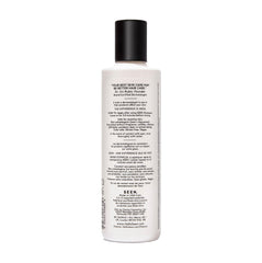 SEEN conditioner creamy texture on fingertips demonstrating lightweight spreadability