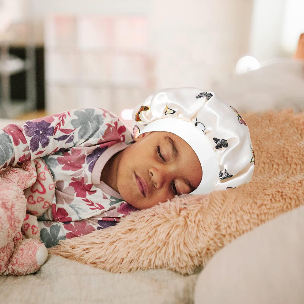 Child wearing Selalu bonnet while resting, demonstrating secure comfortable fit benefit