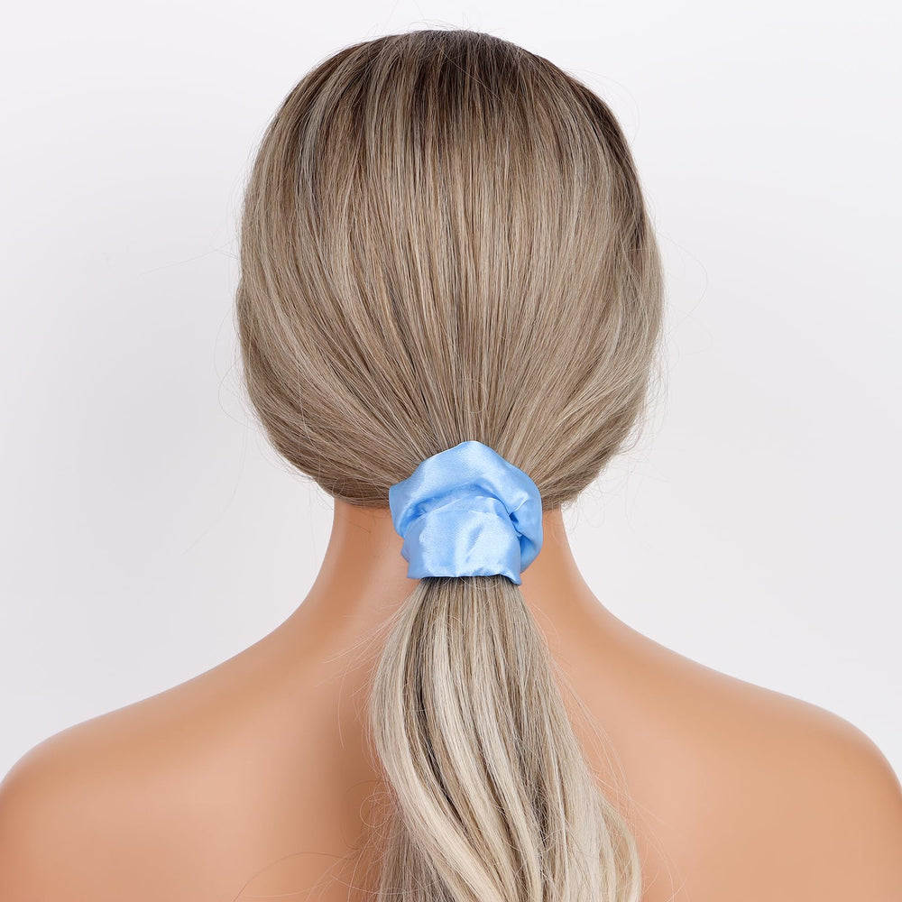 Semato scrunchie beside coins showing scale and portable convenience