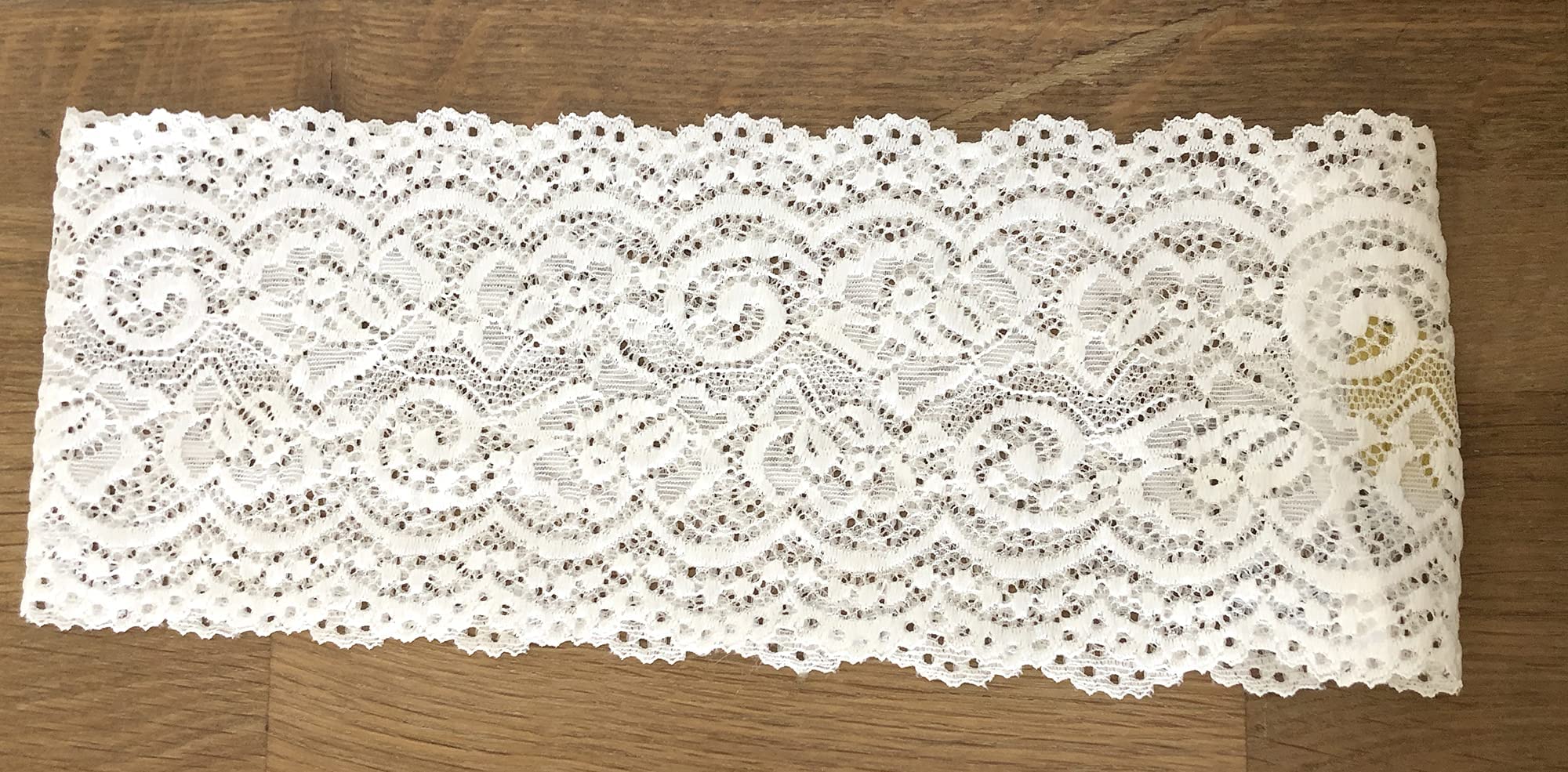 ShariRose headband next to a hand for size scale showing approximate four-inch width