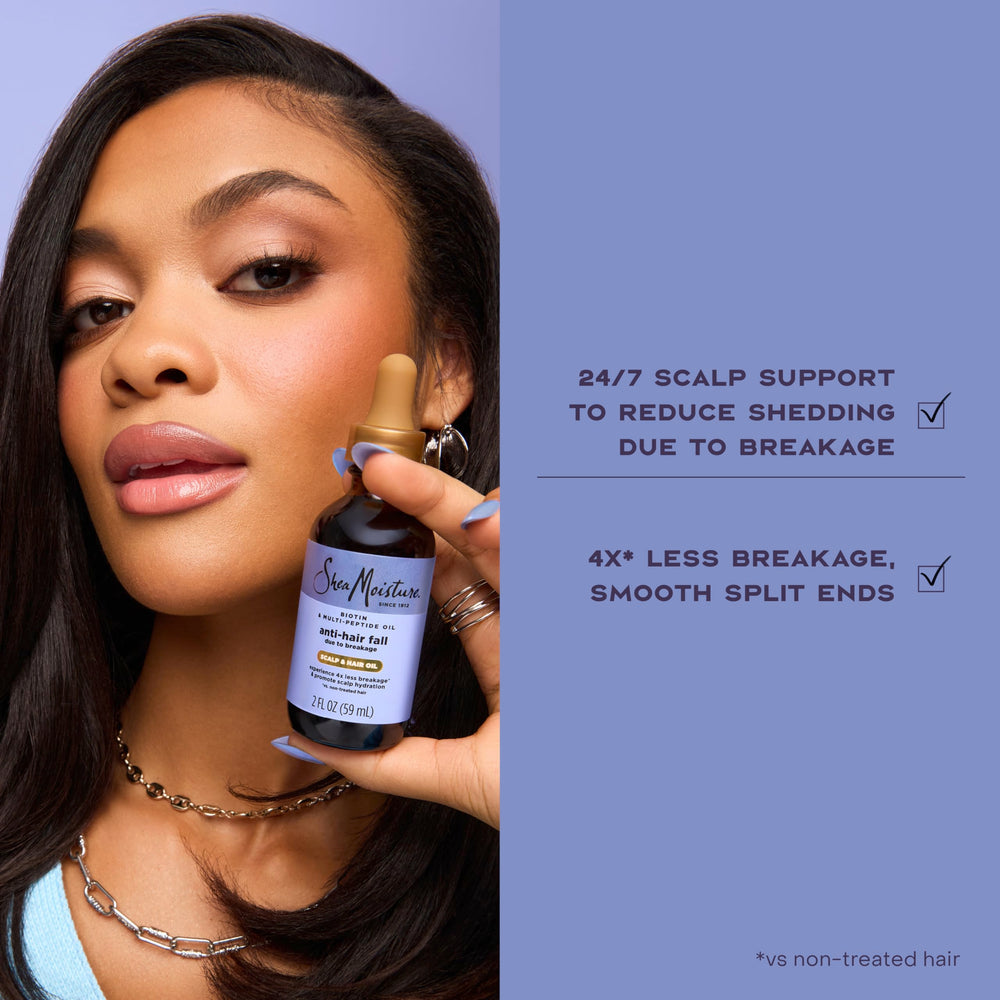 Shea Moisture applying oil to scalp demonstrating easy massage