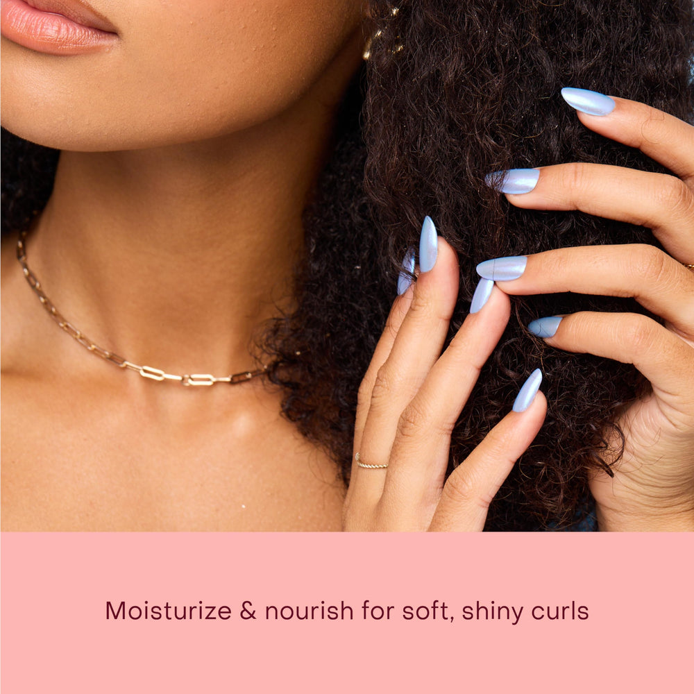Shea Moisture applied on curly hair to show frizz reduction and enhanced curl definition benefit