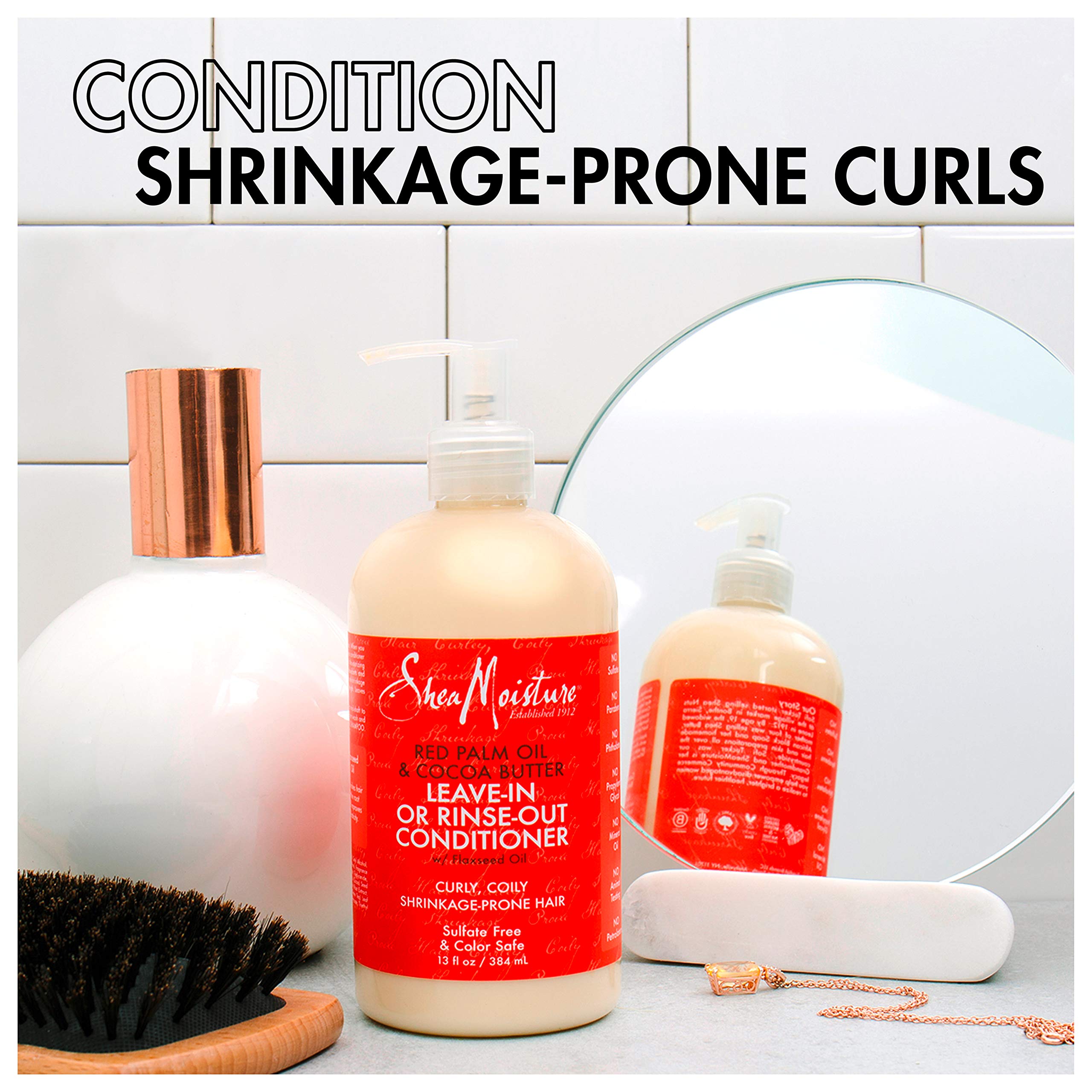 SheaMoisture 13 oz conditioner held in hand showing size and easy dispensing