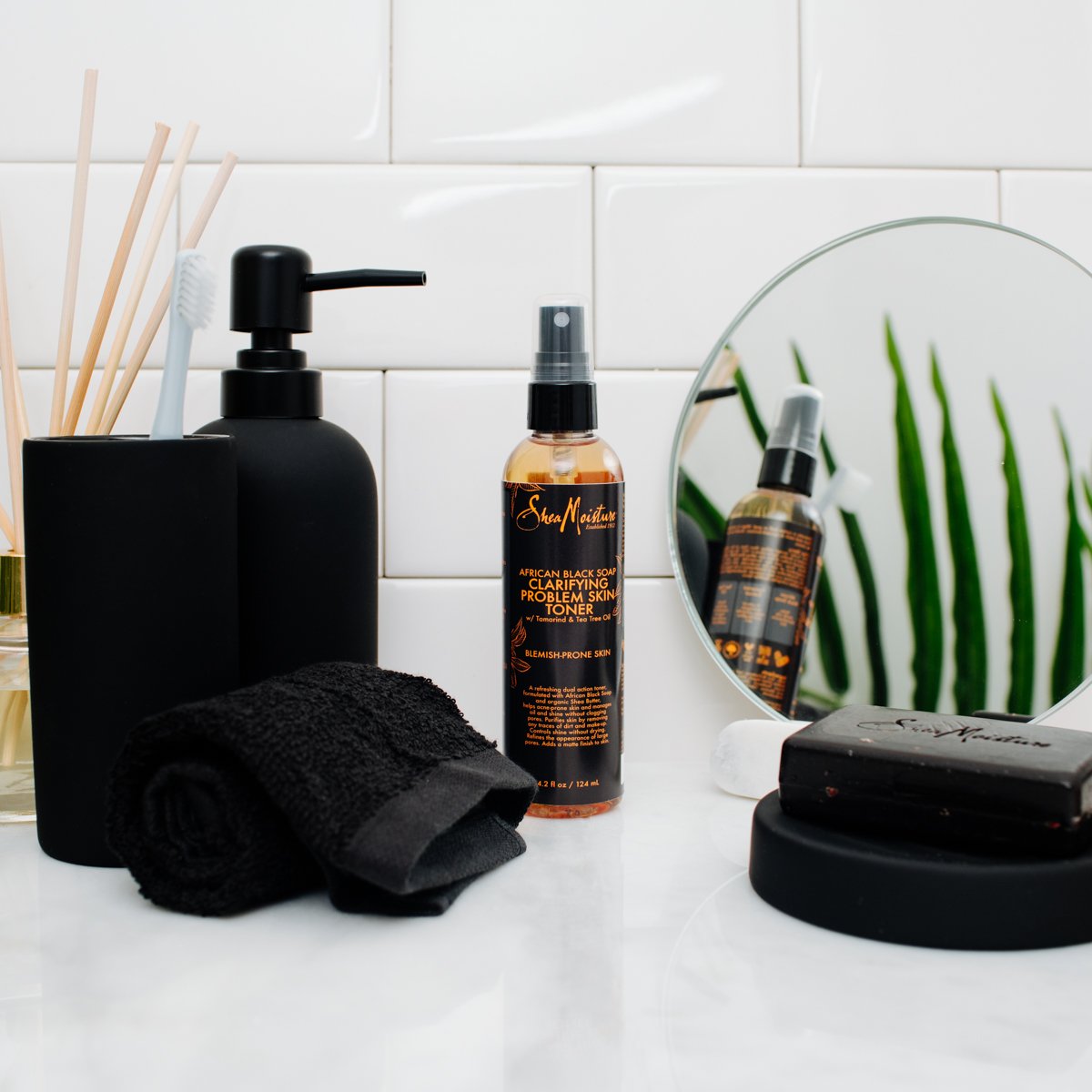 Shea Moisture toner on bathroom shelf suggesting daily routine benefit
