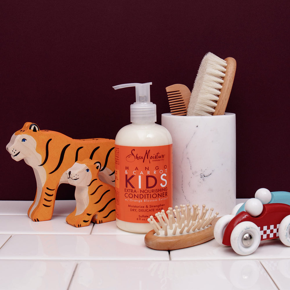 Shea Moisture family using conditioner in bathroom illustrating gentle daily care