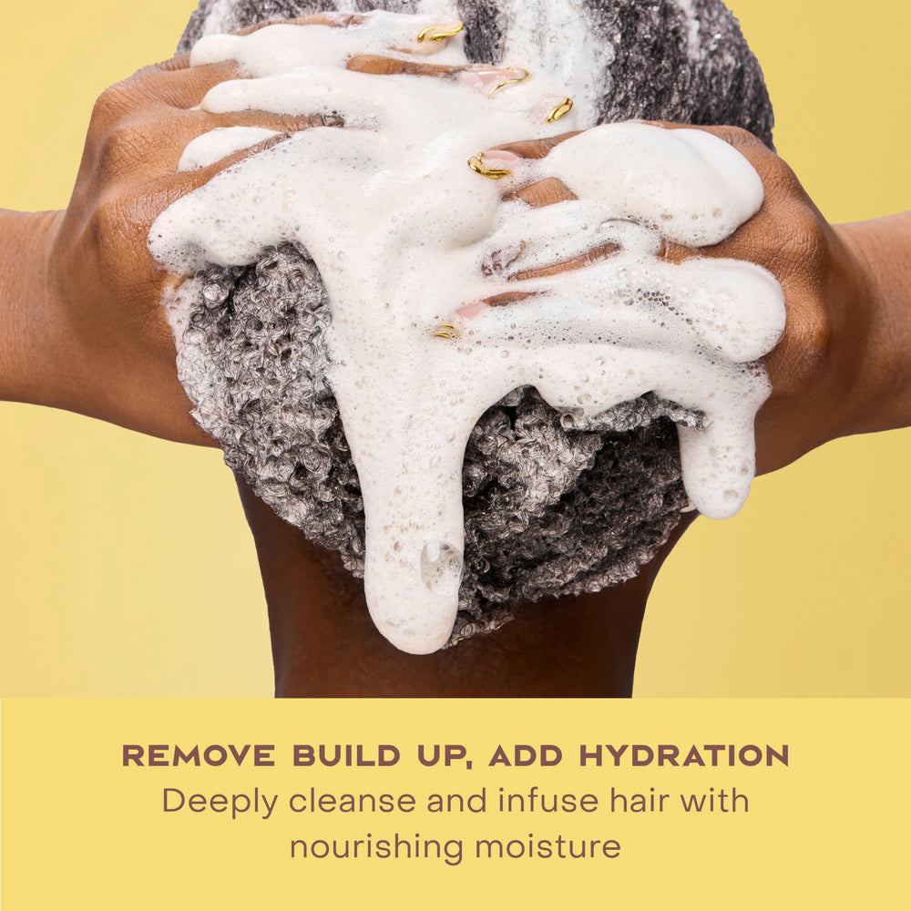 SheaMoisture shampoo on curly hair in shower demonstrating slip