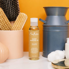 SheaMoisture pouring oil into hand demonstrating quick absorption benefit