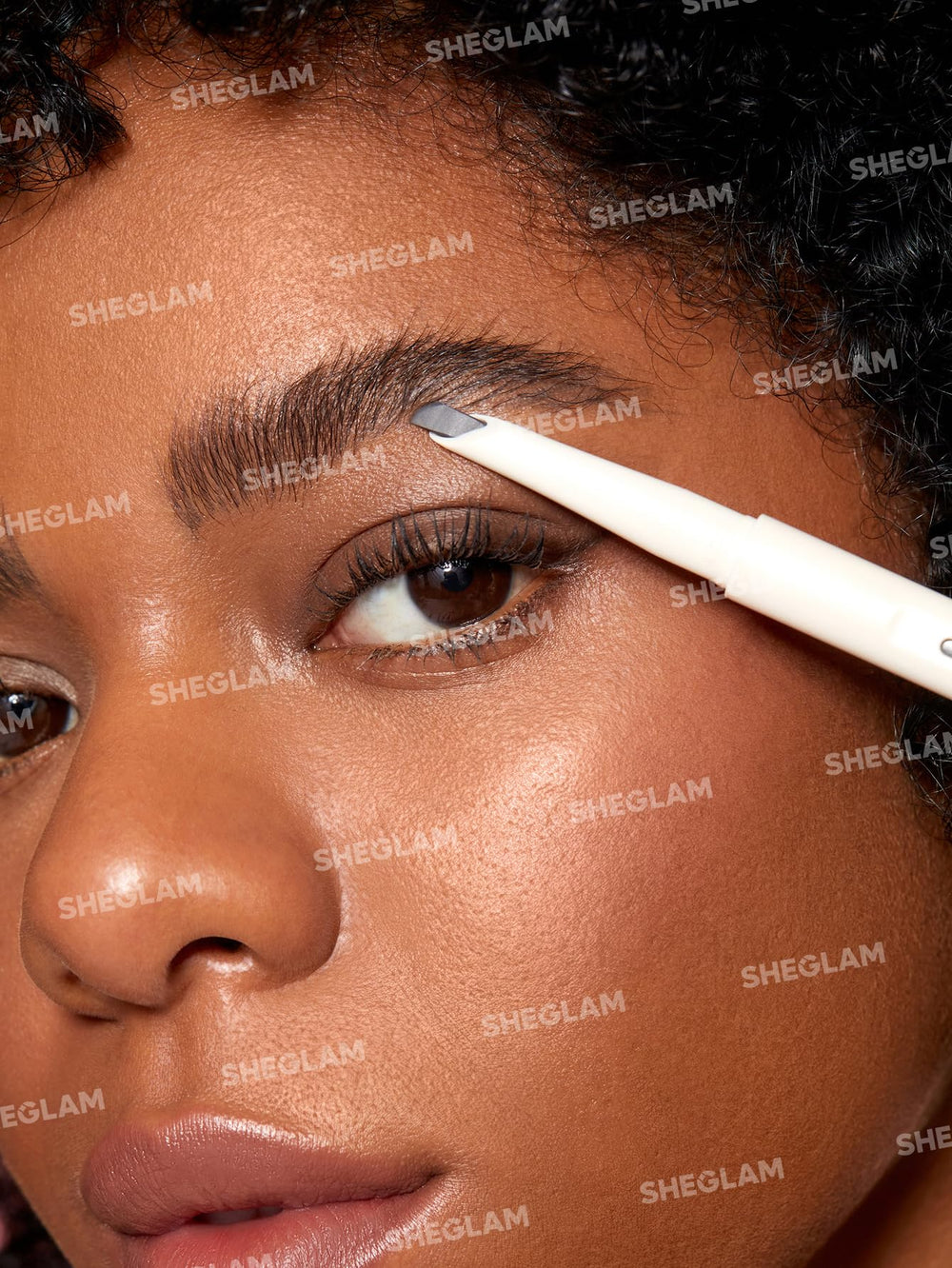 SHEGLAM pencil held in hand to show true size for easy touch-ups