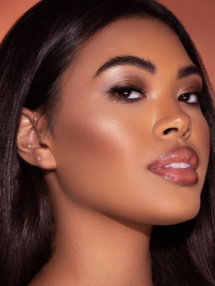 SHEGLAM swatch on medium-warm skin demonstrating Bellini Brunch warm champagne-peach glow