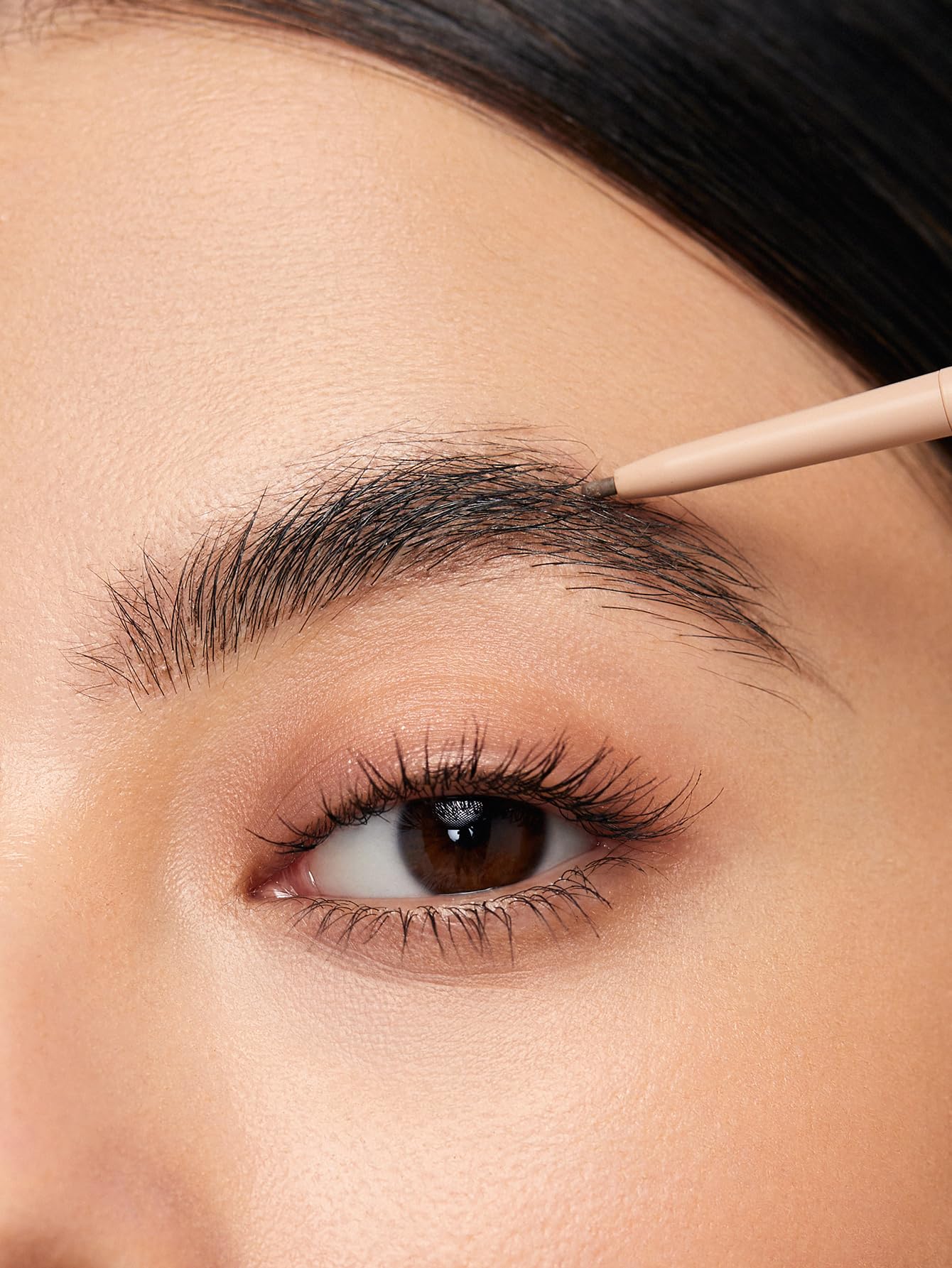 SHEGLAM pencil held in hand to show size and easy control benefit