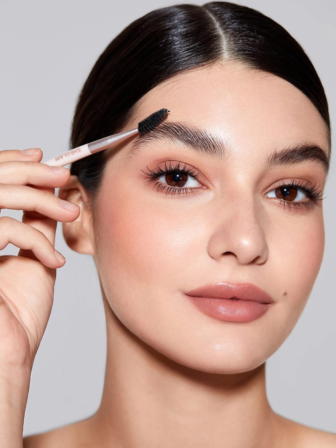 SHEGLAM model wearing groomed brows showing natural hold and confidence benefit