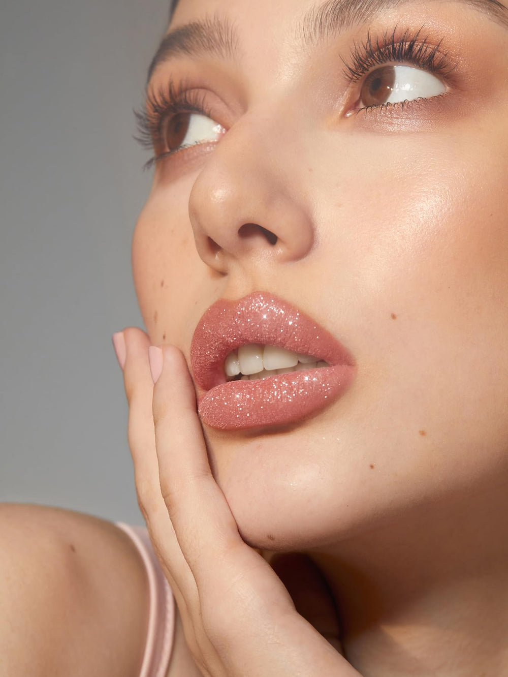 SHEGLAM fine glitter particles close-up showing reflective sparkle benefits