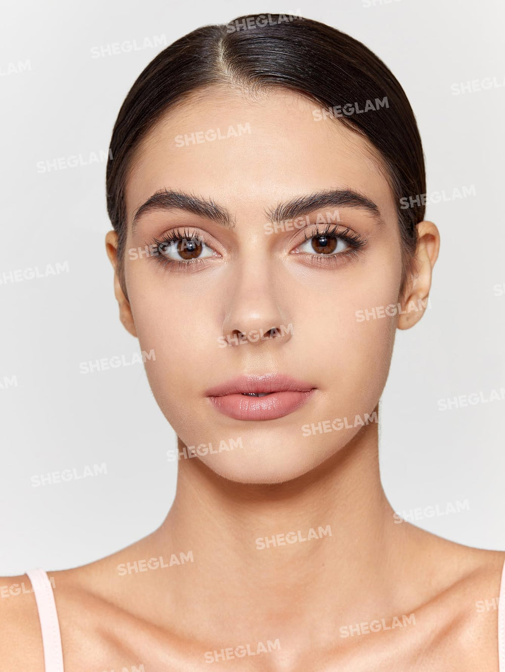 SHEGLAM spray being applied to face for long-lasting makeup hold and oil control