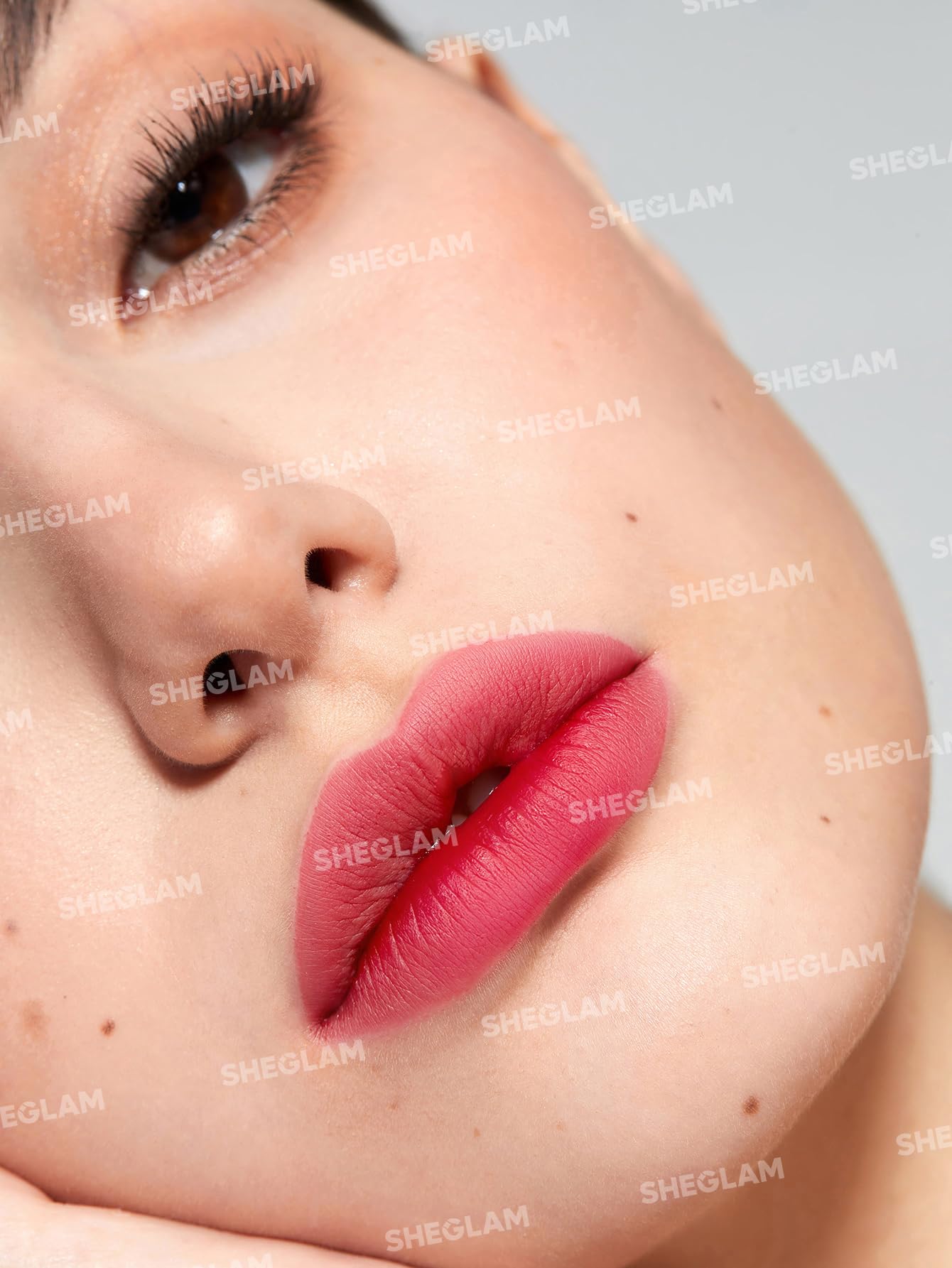 SHEGLAM lip tint being peeled to reveal long-lasting stain underneath