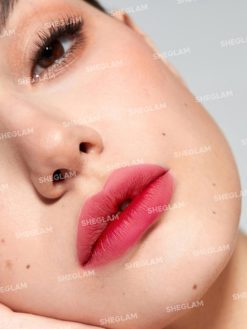 SHEGLAM lip tint being peeled to reveal long-lasting stain underneath