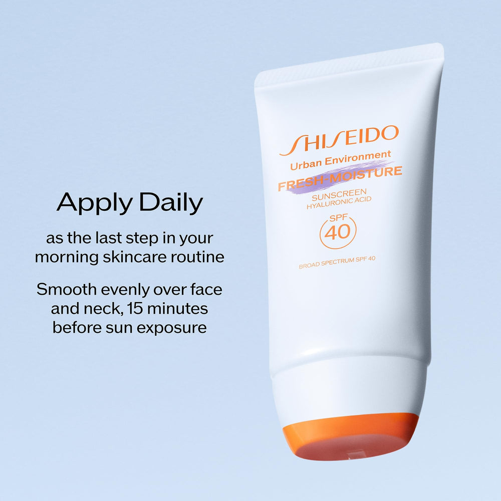 Shiseido sunscreen beside coin for 50 mL size comparison and portability benefit