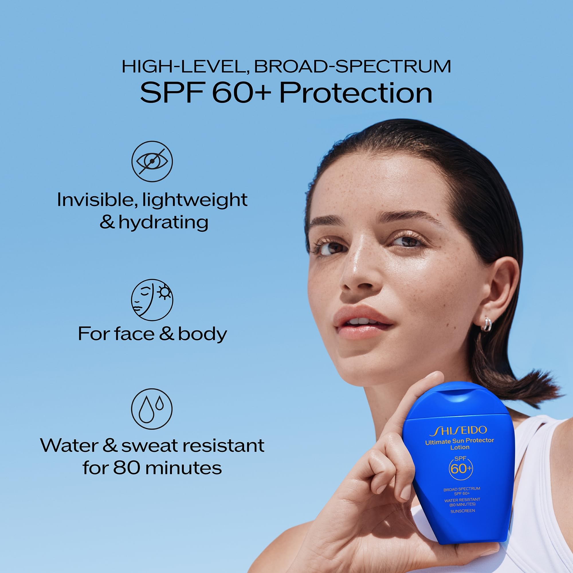 Spreading Shiseido sunscreen on arm showing full-body application coverage