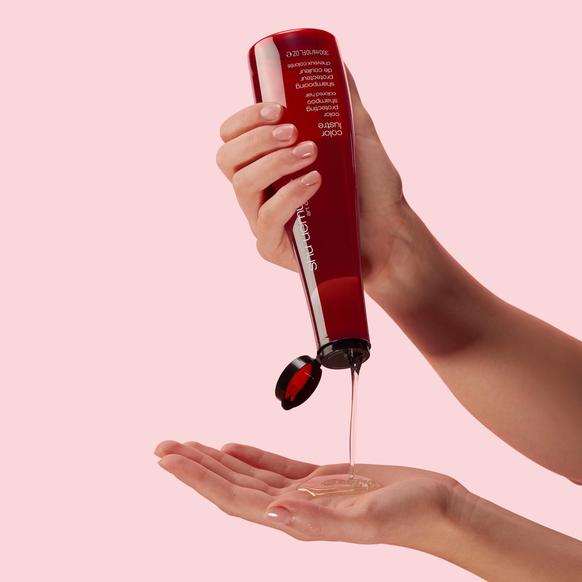 shu uemura 10 oz bottle beside common items to show scale and portability