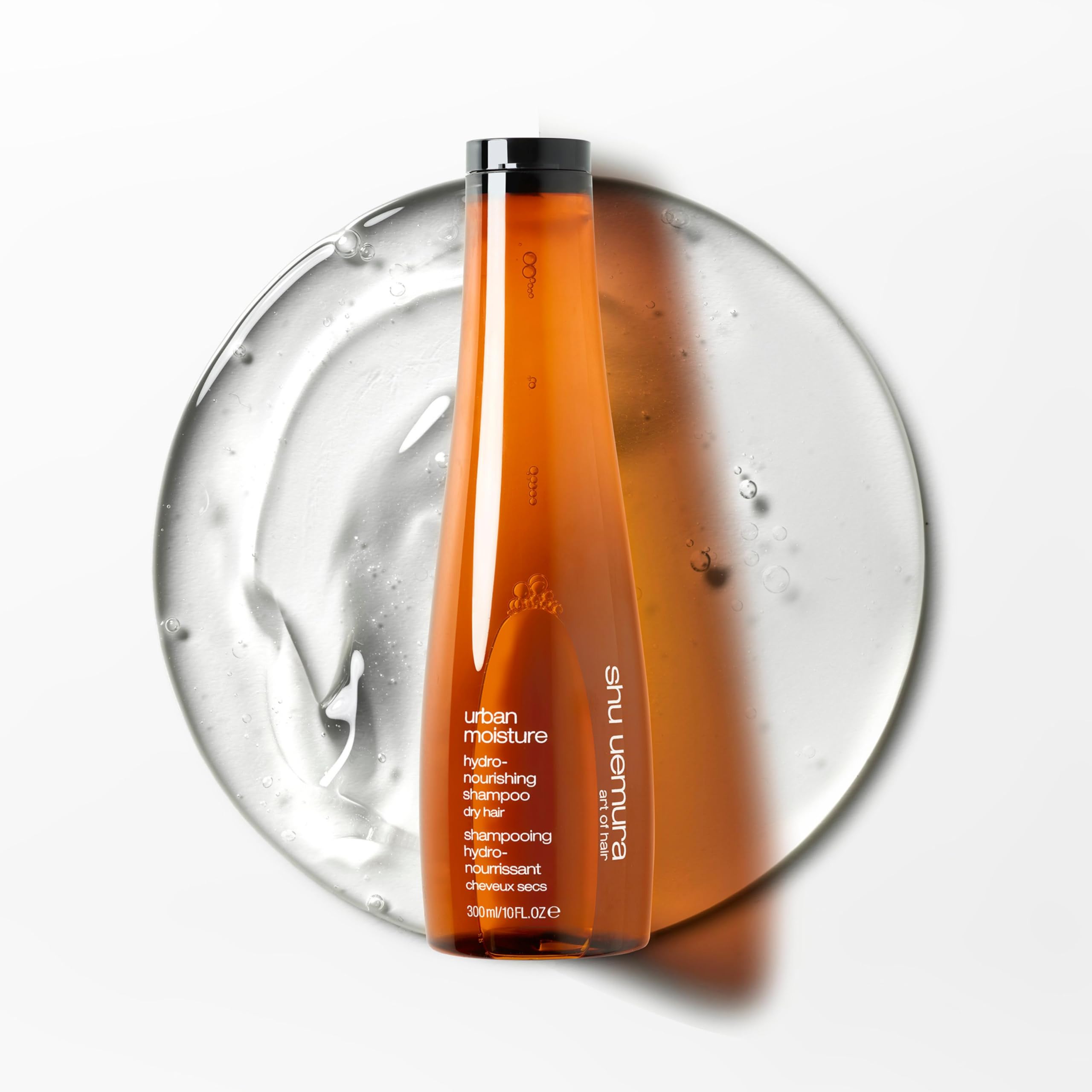 shu uemura bottle in hand indicating 10 fl oz size for travel and everyday use convenience