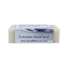 Silver Miracles soap held in hand by user in bathroom, demonstrating size and travel-friendly convenience