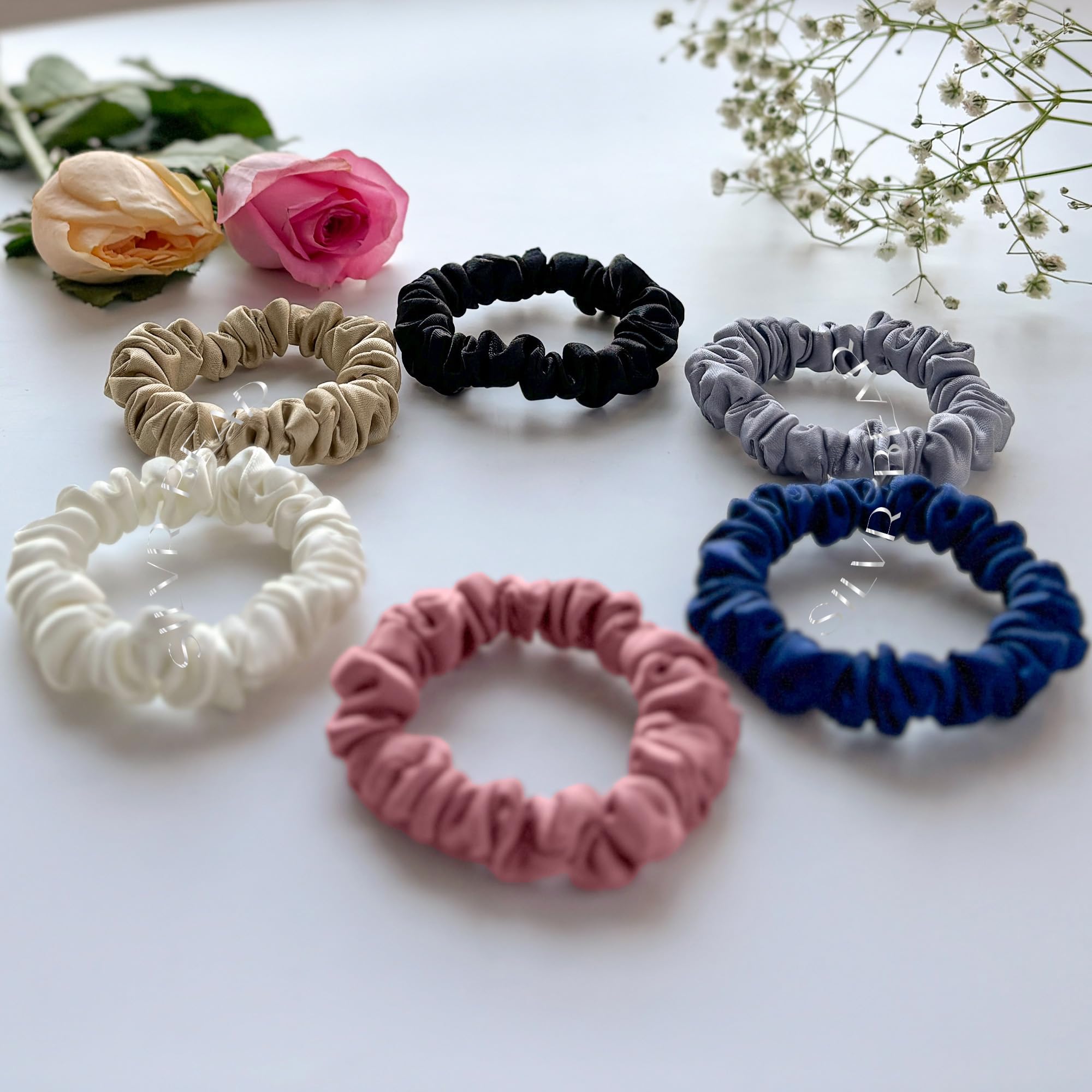 Silvr Bear scrunchie beside a coin to show compact size and travel readiness