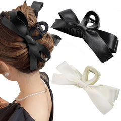 Sizobi front view of black and white bow clips showing elegant hold