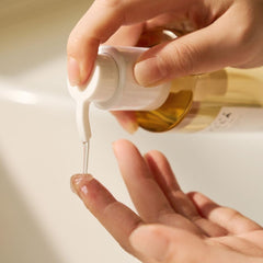 SKIN1004 cleansing oil on bathroom shelf with towel, suggesting daily skincare routine
