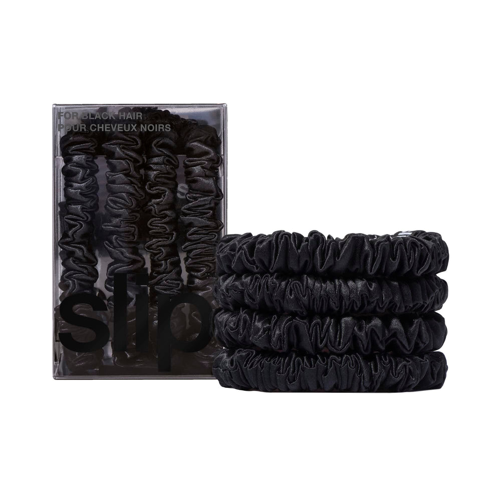 SLIP front packaging showing four black silk skinny scrunchies, elegant gift-ready