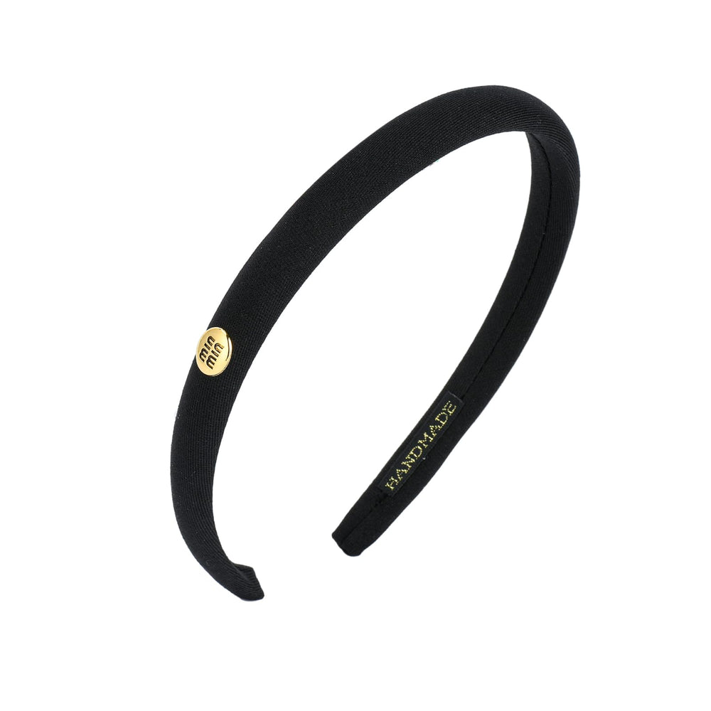 Sluxa front view headband showing slim lettered design and polished finish for style