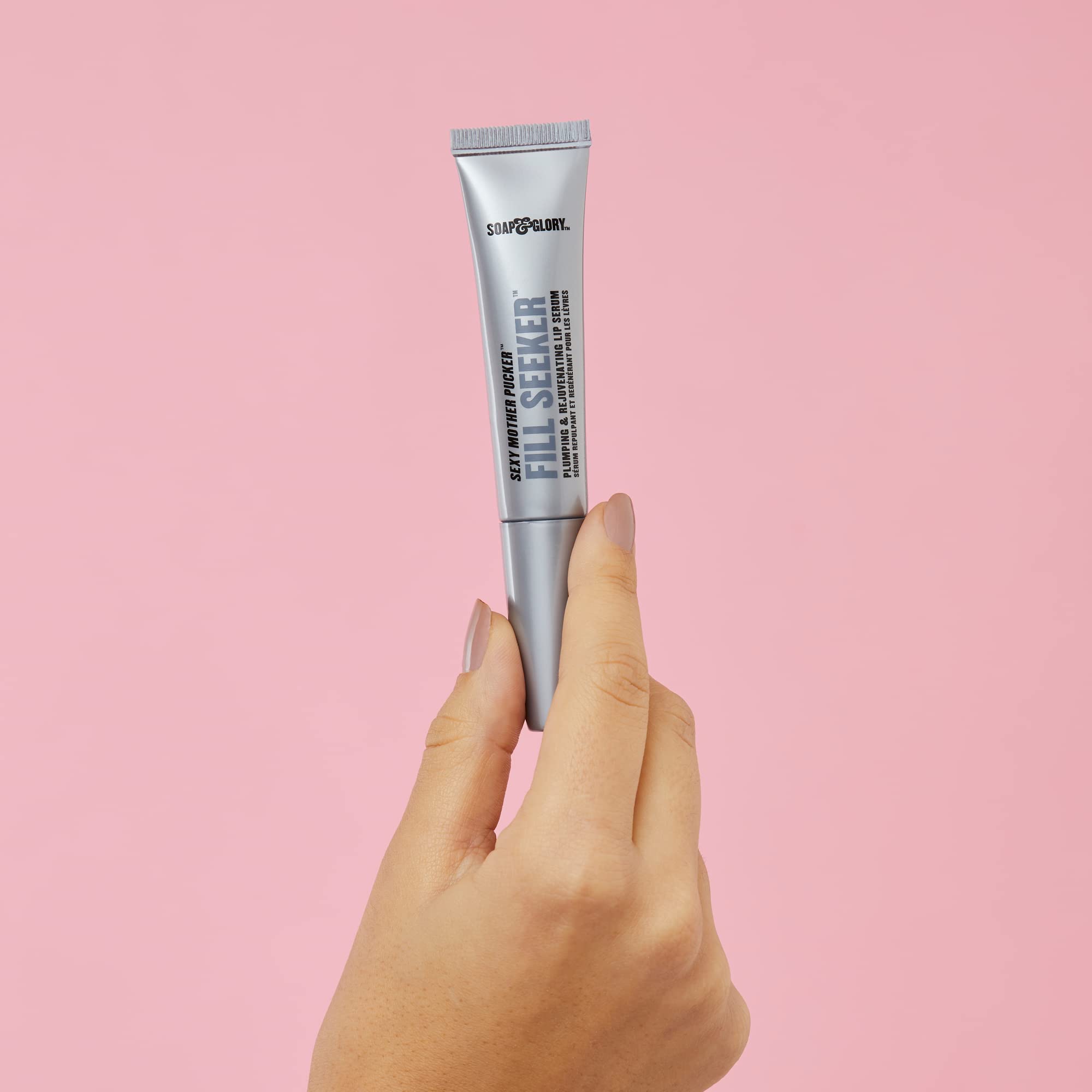 Soap & Glory gloss held in hand for scale showing compact travel size benefit